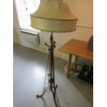 Early 20th Century brass standard lamp with three splayed supports,