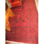 Mid to late 20th Century Afghan carpet with three rows of eight gols on a typical wine ground with