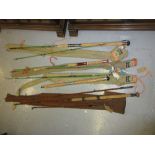 Four various fishing rods to include: a three piece split cane sea rod,