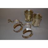 Pair of plated bottle carriers, pair of embossed floral decorated beakers,