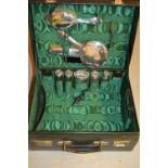 Ladies black leather dressing case containing various silver topped bottles, brushes,