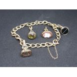 9ct Gold curb link bracelet together with four various fob charms
