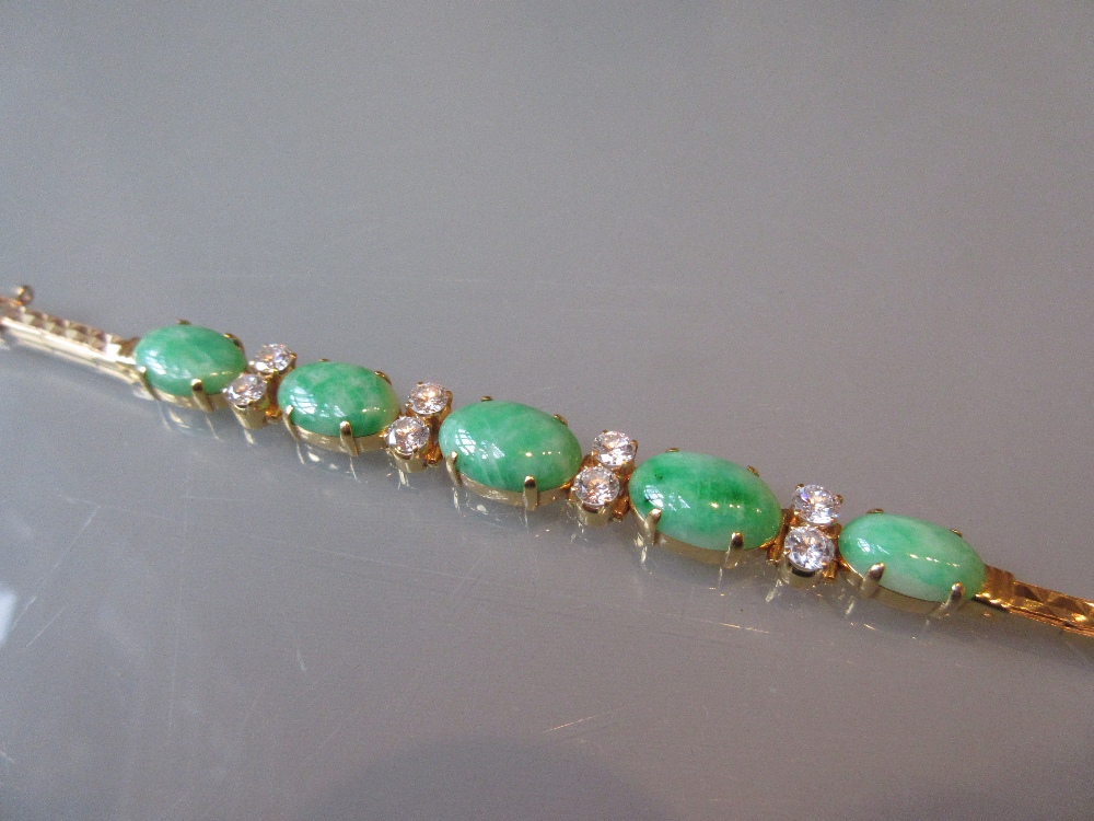 Far Eastern high carat yellow metal bracelet set five graduated oval green jade panels interspersed - Image 2 of 2