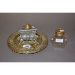 Circular brass and spelter inkwell together with a hexagonal glass inkwell with brass cover