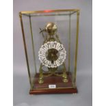 Brass Gothic style skeleton clock having a single train movement striking on a bell with white