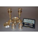 Pair of modern silver pepper grinders, pair of silver pedestal dishes, pair of silver candlesticks,