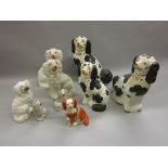 Pair of large 19th Century Staffordshire black and white figures of seated spaniels (at fault),