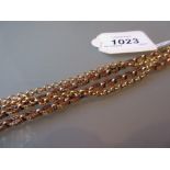 Yellow metal neck chain of pierced design with a brass clasp together with a gold plated neck chain