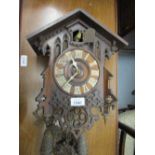 Continental cuckoo clock in Gothic style carved case with later painted Roman numerals,