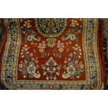 Indo Persan rug with floral design on red ground together with a Numdah rug and an Afghan mat
