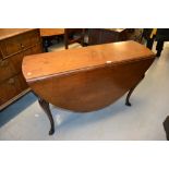 George III possibly Irish mahogany oval drop-leaf dining table raised on carved cabriole and pad