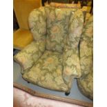 19th Century floral upholstered wing back armchair raised on low cabriole supports