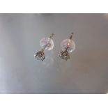 Pair of platinum diamond set ear studs CONDITION REPORT Approximately 1/8 ct