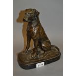 Brown patinated bronze figure of a seated dog