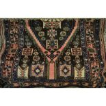 Kurdish rug with a single lobed medallion and all-over geometric design in shades of rose pink,