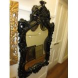 20th Century black wall mirror with composition frame in an antique style,