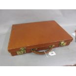 Small brown leather suitcase