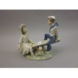 Lladro figural group of a girl and boy on a seesaw