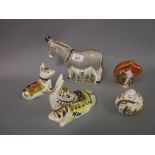 Three Royal Crown Derby paperweights in the form of donkeys together with two others in the form of