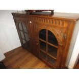 Reproduction oak two door bookcase together with a similar standing corner cabinet