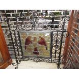 Good quality Arts and Crafts wrought iron fire screen inset with a leaded glass panel painted with