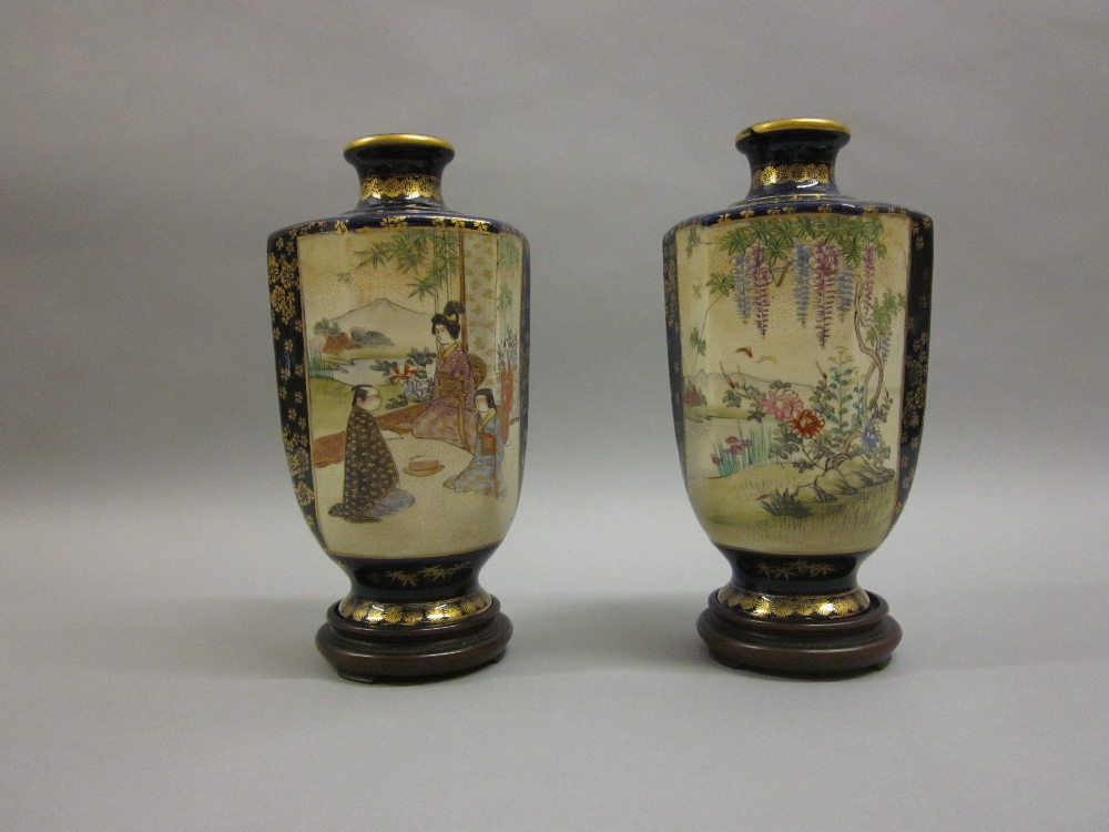 Pair of Satsuma hexagonal pottery vases painted with panels of figures and a landscape