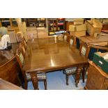 Edwardian oak wind-out extending dining table with two extra leaves raised on turned fluted