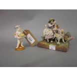 Continental porcelain group of mother and child with a dog and a smaller porcelain figure of a
