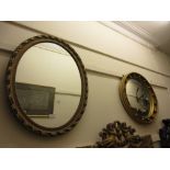20th Century gilt framed circular convex wall mirror and an oval gilt framed wall mirror