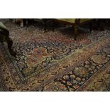 Meshed carpet with a medallion and all-over stylised floral design on a wine red ground with