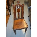 Set of three 19th Century Gothic style hall chairs with painted family crests to the pierced