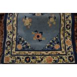 Chinese rug with floral design on a pale blue ground with borders
