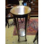Circular mahogany line inlaid two tier torchere on splayed supports,