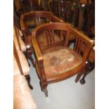 Pair of 20th Century oak bow and slat back office armchairs having leather upholstered seats on