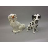 Large Staffordshire flat back of a seated dog and another modern porcelain figure of a seated