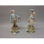 Pair of Continental porcelain figural and floral encrusted candelabra bases