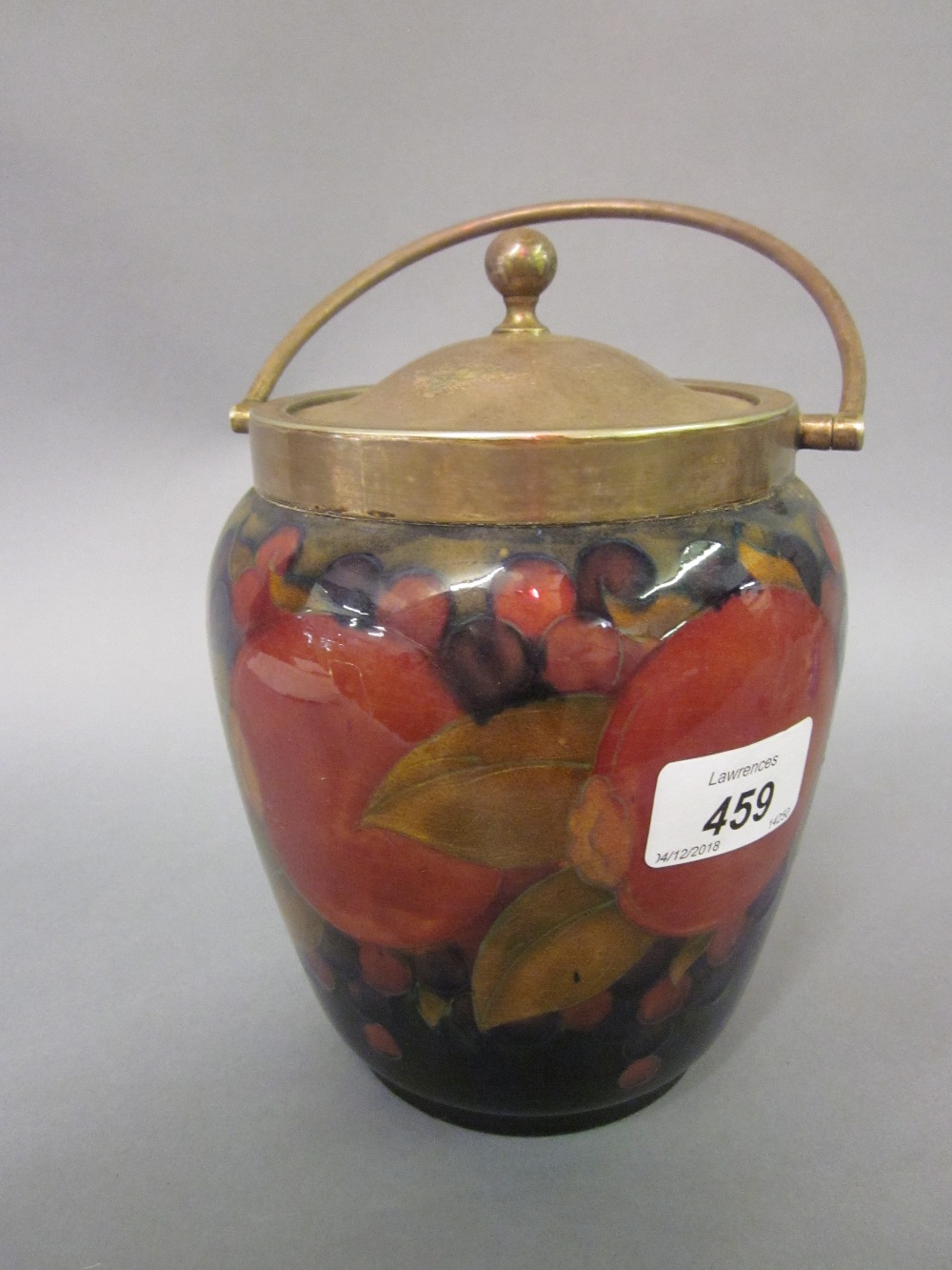 Moorcroft biscuit barrel with silver plated mounts decorated with the pomegranate and grape design,