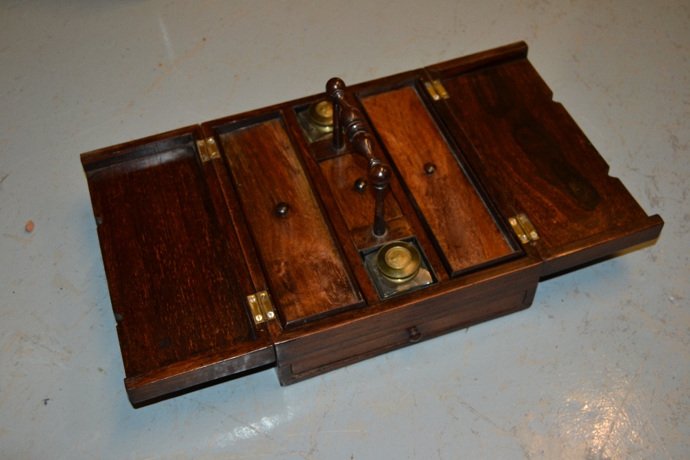 Victorian rosewood writing box with a twin hinged lid enclosing ink bottles and compartments above