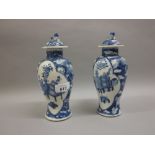 Pair of Chinese blue and white baluster form porcelain vases with covers, decorated with panels,