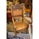 Good quality oak Wainscot chair by Trevor Lawrence of Oxted, with a carved and panelled back,