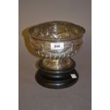 Early 20th Century Sheffield silver rose bowl with embossed swag design mounted on a wooden plinth