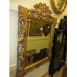 19th Century carved and gilded rectangular bevelled edge wall mirror with cherub surmount,