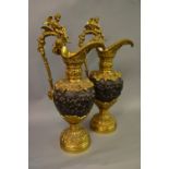 Pair of 19th Century gilt bronze and brown patinated bronze ewers relief moulded with Bacchanalian
