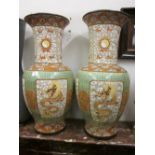 Pair of large Chinese stoneware baluster form vases decorated with figures of dragons within panels,