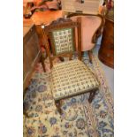 Set of six Edwardian oak dining chairs with carved top rails, padded backs,