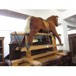 20th Century Pegasus rocking horse the plush covered horse with leather saddle on a wooden base,