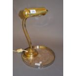 Brass adjustable desk lamp together with a circular silver plated galleried tray