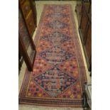 20th Century Turkoman style runner having a single row of six gols with floral decoration and