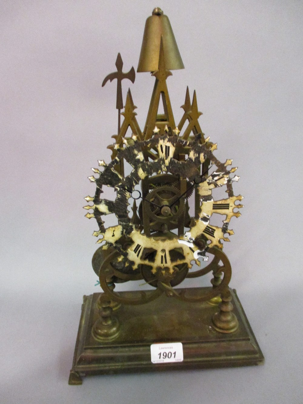 Brass single fusee skeleton clock with posing strike on a bell