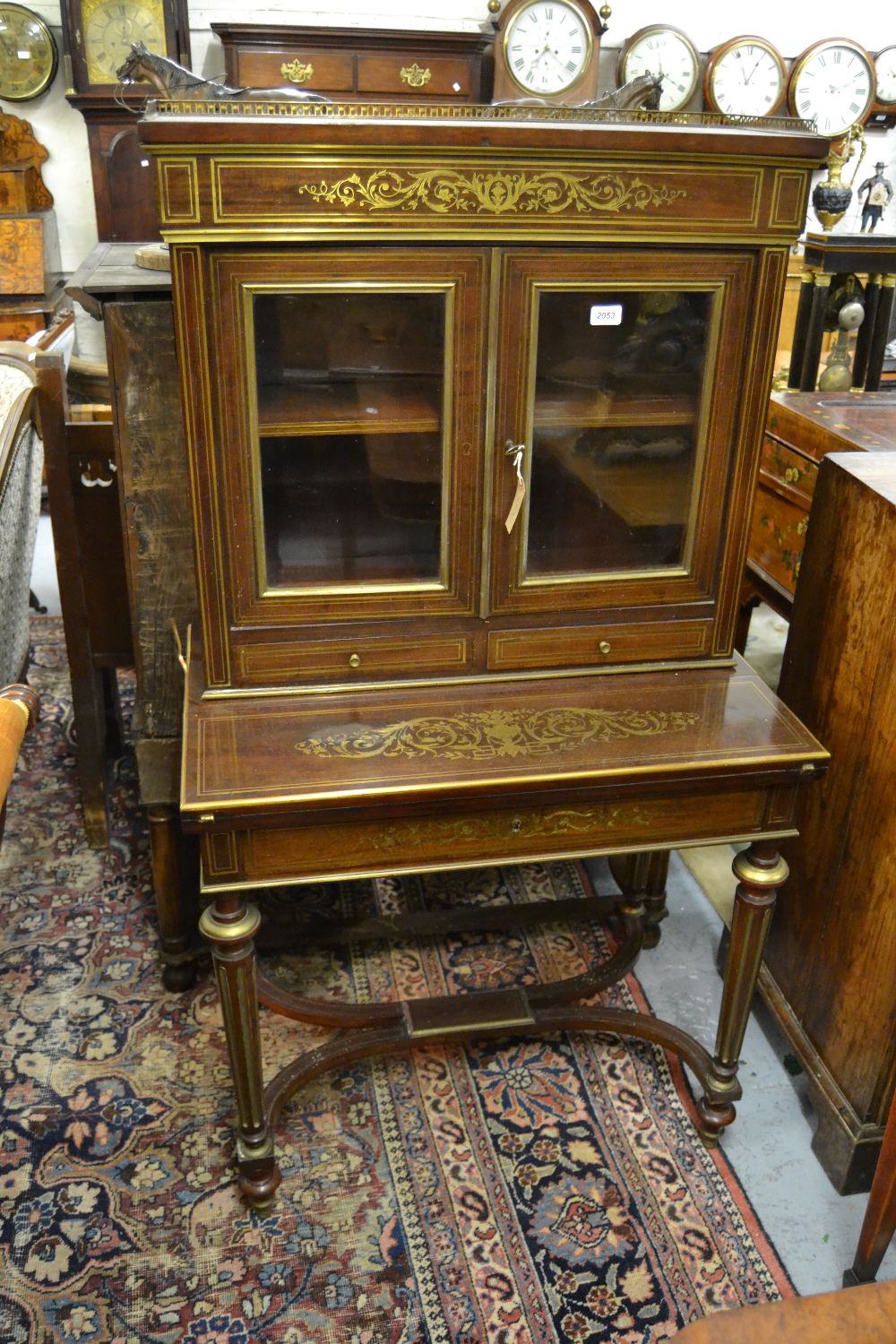 19th Century French mahogany brass inlaid bonheur du jour with a galleried top above two glazed